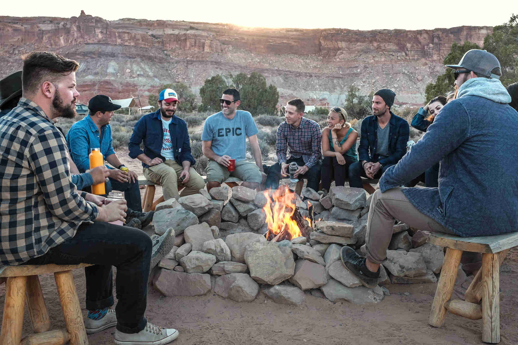 People gathered around an outdoor fire pit in the desert